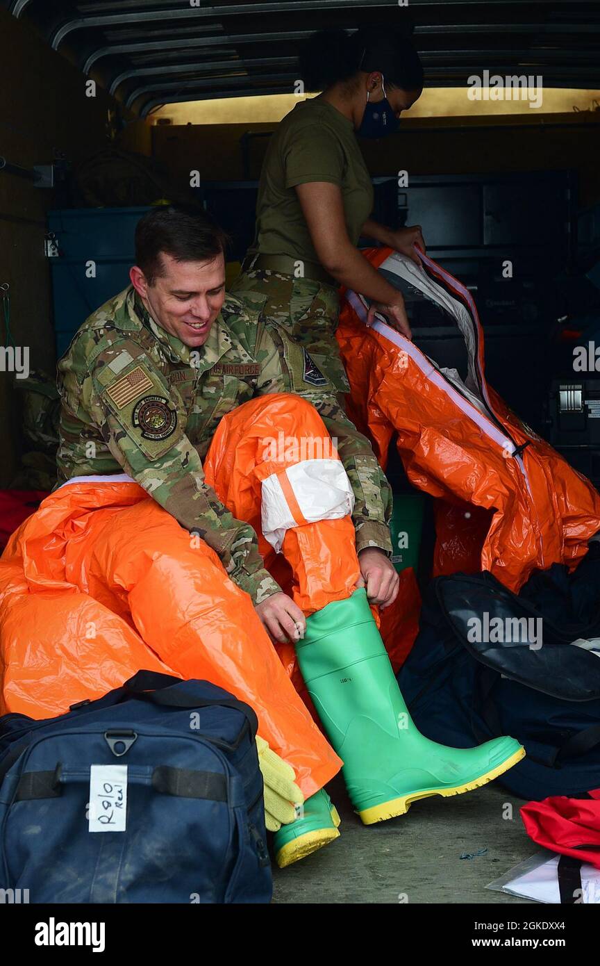 Tech. Sgt. Stephen Johnson, 460th Civil Engineer Squadron emergency management technician, and Senior Airman Selena Little, 460th Civil Engineer Squadron emergency management apprentice, gear up for a hazardous materials and emergency management exercise on Buckley Air Force Base, Colo., March 24, 2021. Johnson and Little suit up in level A hazmat gear to prepare to enter a hazardous building to test and clear it. Stock Photo