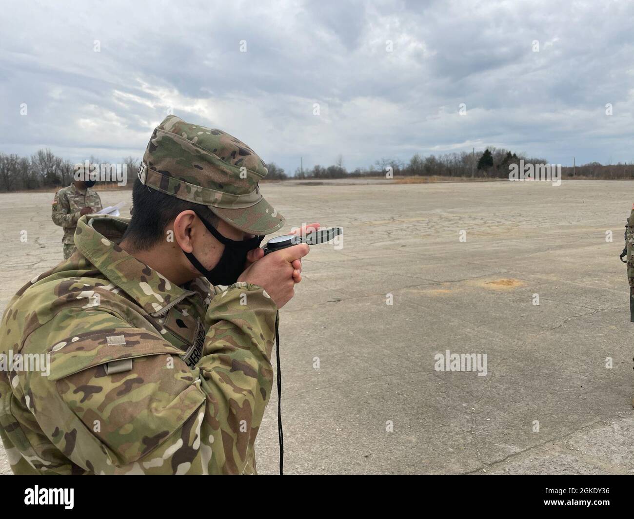 Spc. Alexander Hernandez, financial support specialist, 1st Theater Sustainment Command, practices shooting an azimuth with a compass during land navigation training at Fort Knox, Kentucky, March 25, 2021. Land navigation requires traversing unfamiliar territory using basic tools such as a compass and a paper map to get from one point to another. Stock Photo