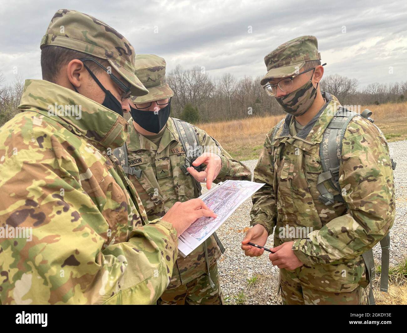 Soldiers of the 1st Theater Sustainment Command plot points on a map during land navigation training at Fort Knox, Kentucky, March 25, 2021. Land navigation requires traversing unfamiliar territory using basic tools such as a compass and a paper map to get from one point to another. Stock Photo