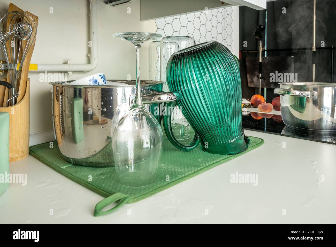 Freshly washed dishes and glasses on a counter put to dry Stock Photo