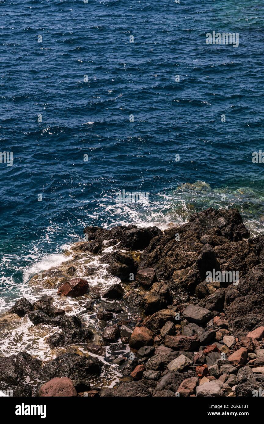 Stone beach of the sea. Top view of the waves and rocks. Close-up ...