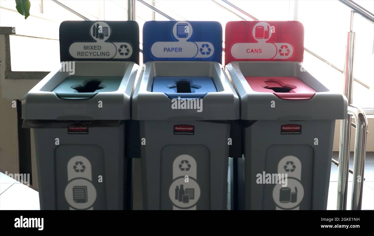 Close up of three public recycle bins. HDR. Waste segregation concept, recycling buckets inside