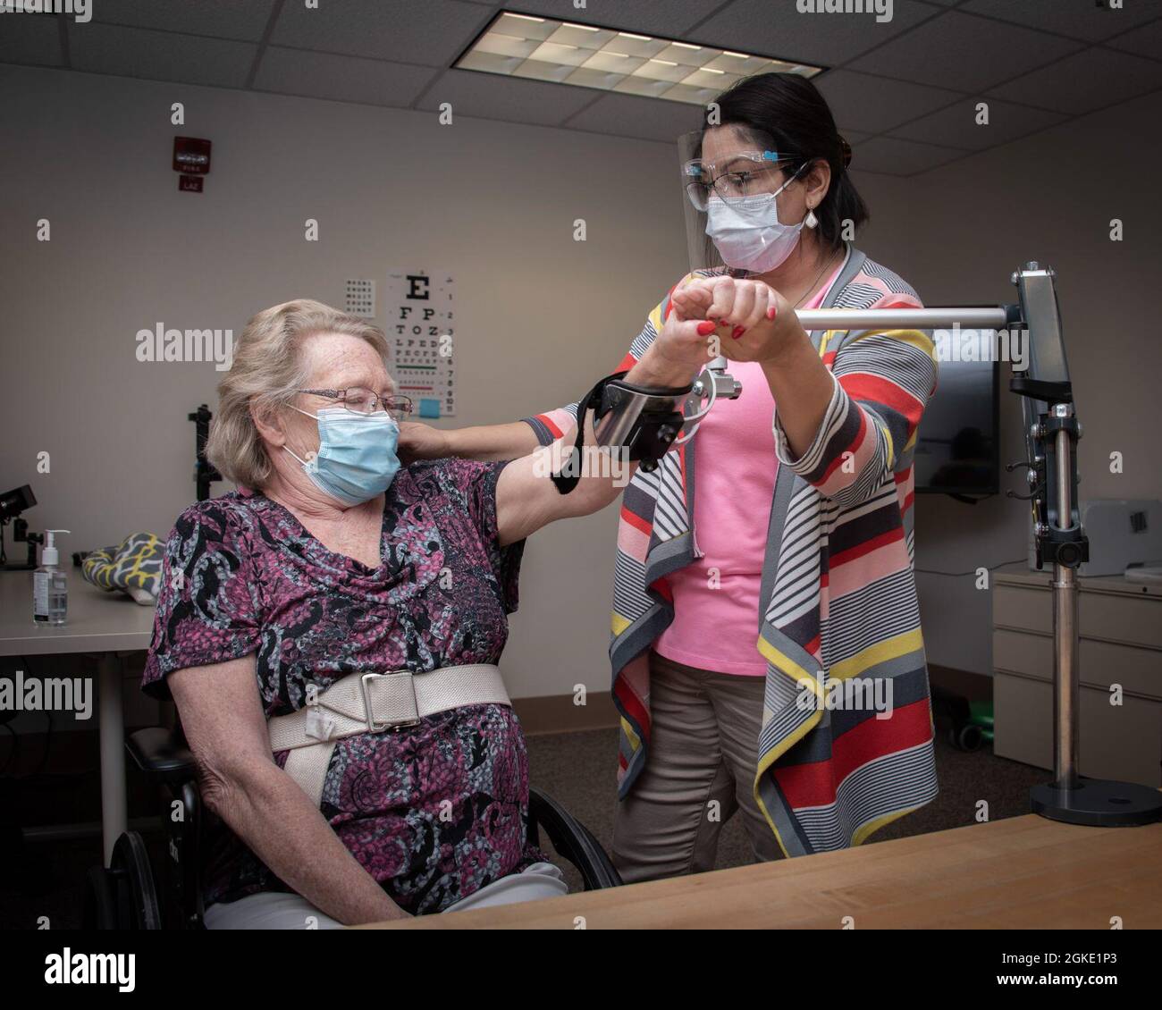 Marina LeBlanc, occupational therapist, helps patient Melody Bowdoin