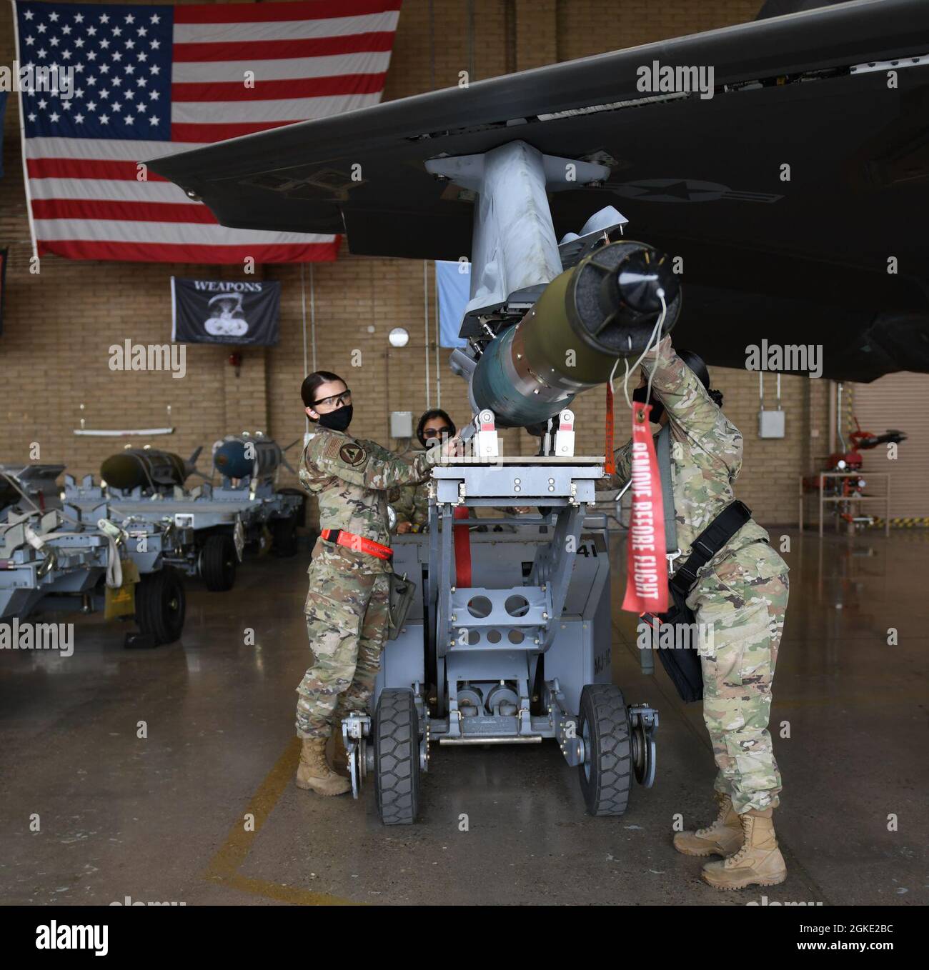 Airman 1st Class Melanie Morgan, left, 63rd Aircraft Maintenance Unit, Senior Airman Zamia Lopez, 61st AMU, and Staff Sgt. Cindy Guillen, 56th Component Maintenance Squadron, weapons load technicians, participate in the Women of Weapons Load Exhibition March 25, 2021, at Luke Air Force Base, Arizona. The team loaded a GBU-12 Paveway II laser-guided bomb on an F-35A Lightning II as part of a Women’s History Month event. Diversity allows the Air Force to capitalize on all available talent by enabling a culture of inclusion. Stock Photo