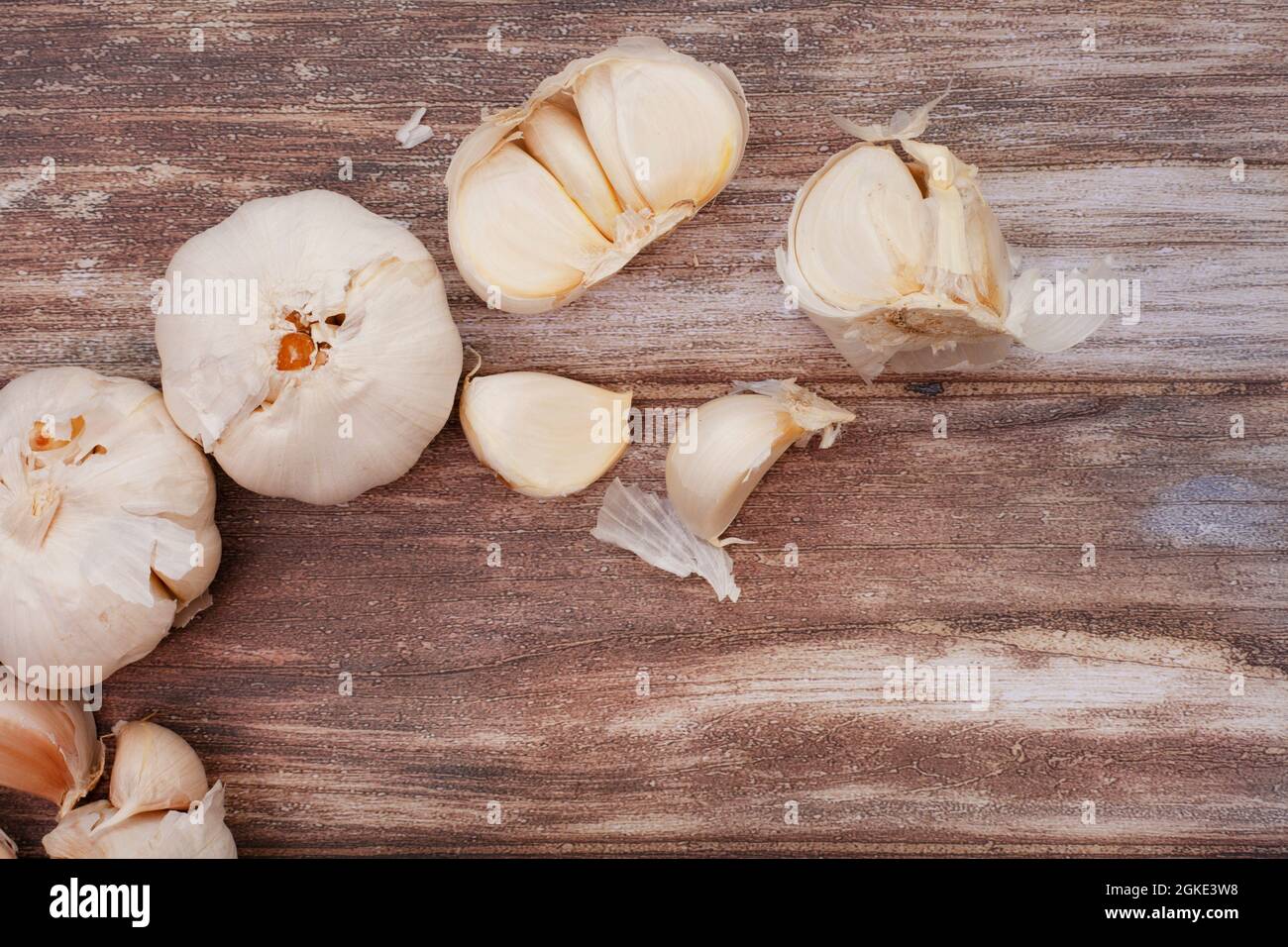 Garlic bulbs and cloves on rustic surface with copy space Stock Photo ...