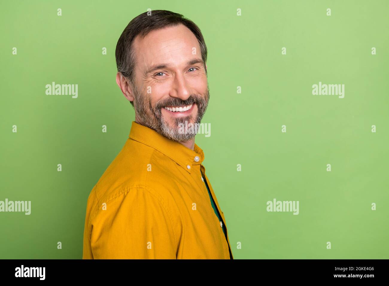 Profile side photo of mature handsome business man happy positive smile isolated over green color background Stock Photo
