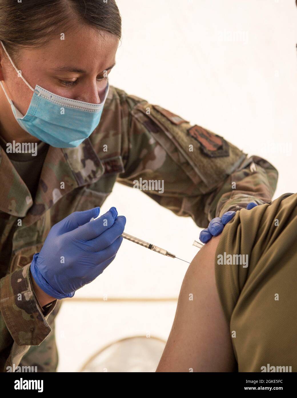 Tech. Sgt. Desiree Ng, a 149th Medical Group Medical Technician with the 149th Medical Group administers a COVID-19 vaccination, March 25, 2021 at Joint Base San Antonio-Lackland, Texas. The 149th Medical Group is ensuring that we keep our Airmen healthy and vaccinated so that they can be mission ready to meet the needs for the Air Force. Stock Photo