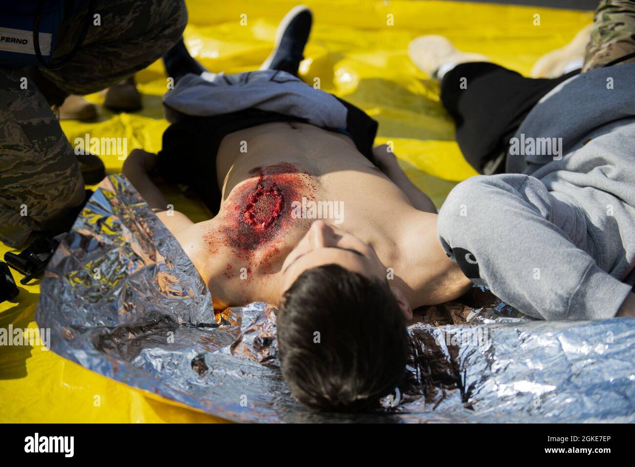 A volunteer for the 52nd Medical Group exercise Ready EAGLE lies on a tarp awaiting simulated medical attention at Spangdahlem Air Base, Germany, March 26, 2021. Exercise Ready EAGLE is a Headquarters Air Force initiative championed by the AF Surgeon General since 2019 to reinvigorate installation medical response programs. Stock Photo