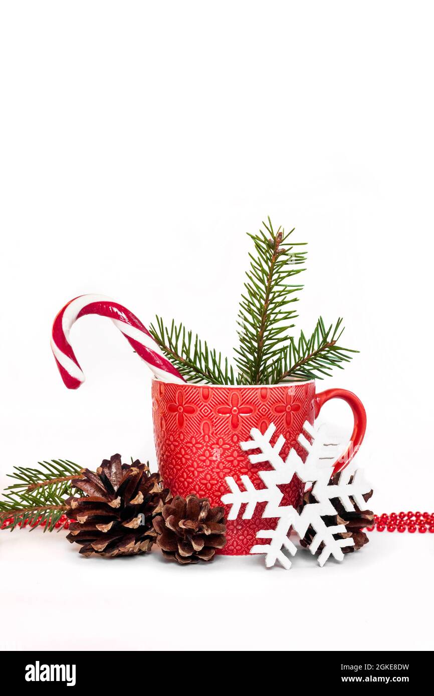 Christmas composition with red mug, pine cones, fir-needles and snowflake. Isolated on white background. Copy space Stock Photo