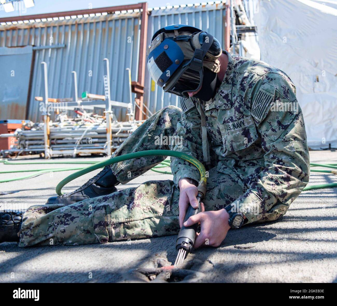 210329-N-SY758-1008 PORTSMOUTH, Va. (March 29, 2021) Aviation Maintenance Administrationman Airman Jacob Salters, from Kimberly, Alabama, uses a needle gun to clean a padeye on the flight deck aboard the aircraft carrier USS George H. W. Bush (CVN 77). GHWB is currently in Norfolk Naval Shipyard for its Docking Planned Incremental Availability. Stock Photo