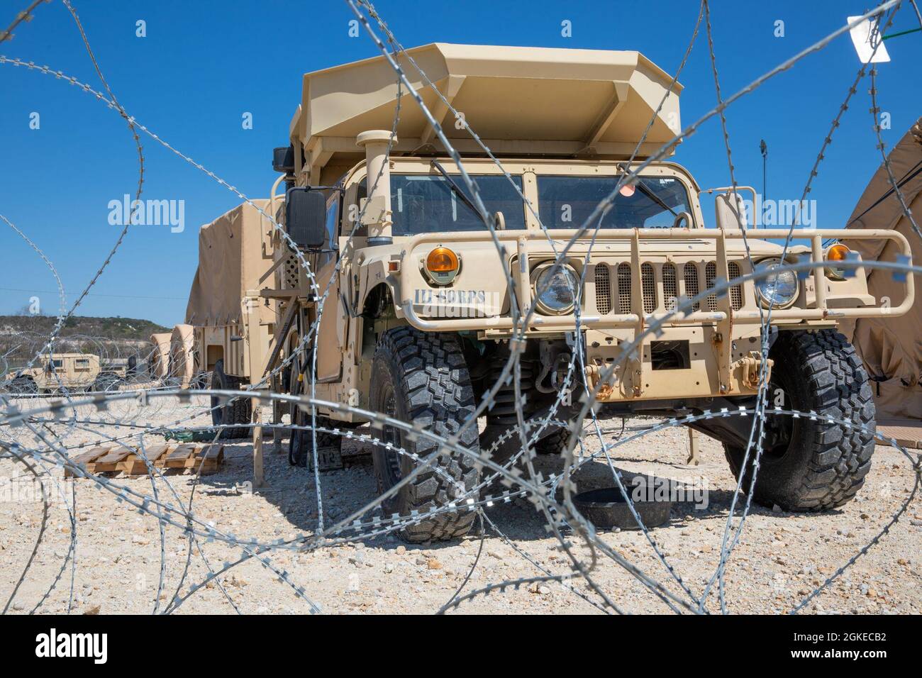 A III Corp Humvee sits behind a concertina wire barrier during ...