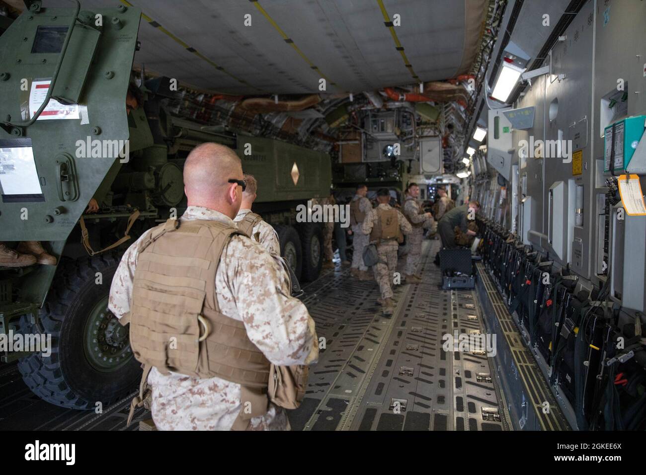 U.S. Marines with Battery Q, 5th Battalion, 11th Marines, 1st Marine Division, load onto a C-17 Globemaster III with 6th Airlift Squadron at Marine Corps Air Station Miramar, California, Mar. 30, 2021. The Marines were transported to Marine Corps Air Ground Combat Center Twentynine Palms to conduct a missile range training exercise to maintain military occupational specialty proficiency. Stock Photo