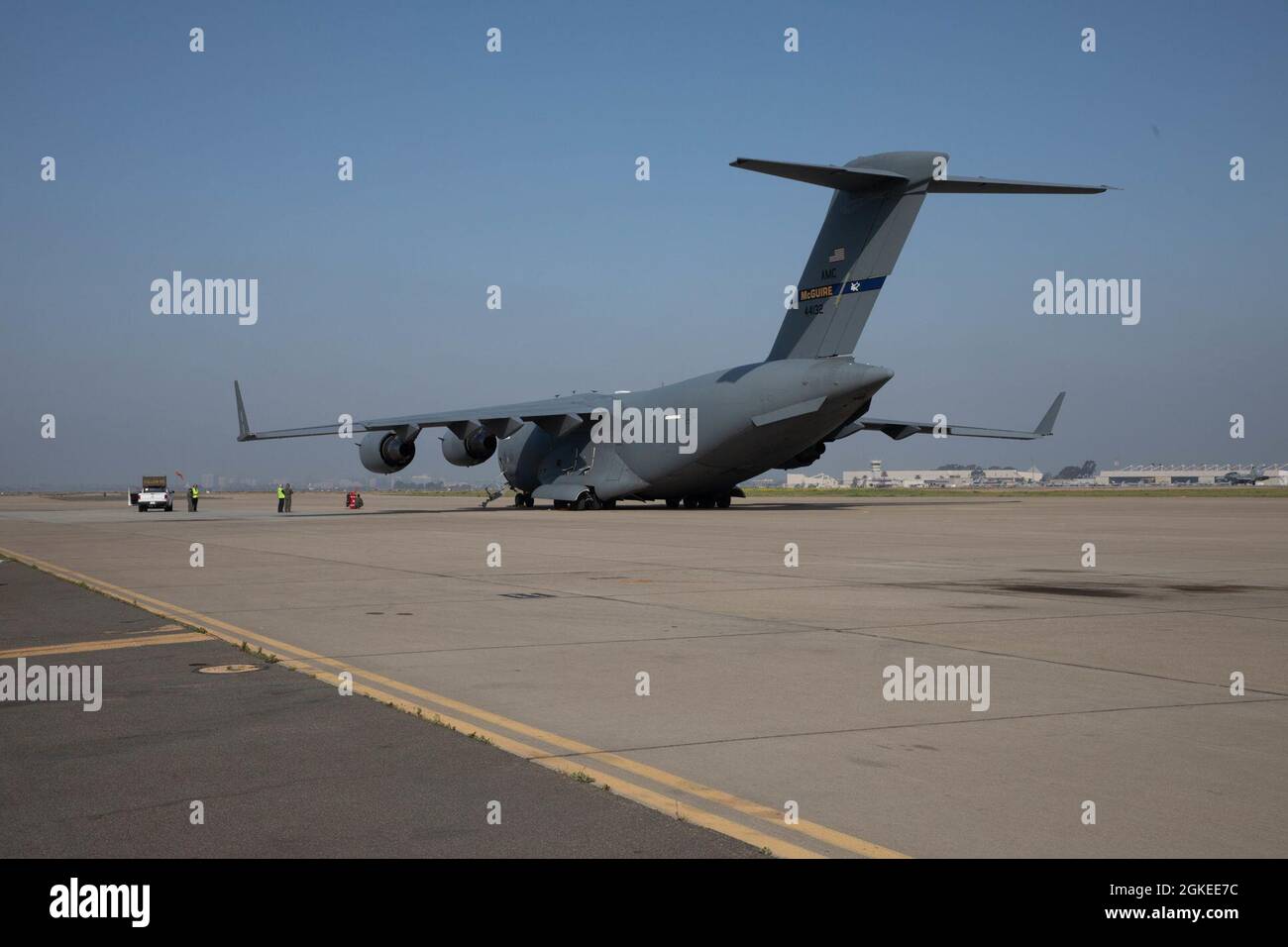 A U.S. Air Force C-17 Globemaster III with 6th Airlift Squadron is staged on the flight line at Marine Corps Air Station Miramar, California, Mar. 30, 2021. The squadron loaded two High Mobility Artillery Rocket Systems and two High Mobility Multipurpose Wheeled Vehicles for transport to Marine Corps Air Ground Combat Center Twentynine Palms for training to maintain military occupational specialty proficiency. Stock Photo