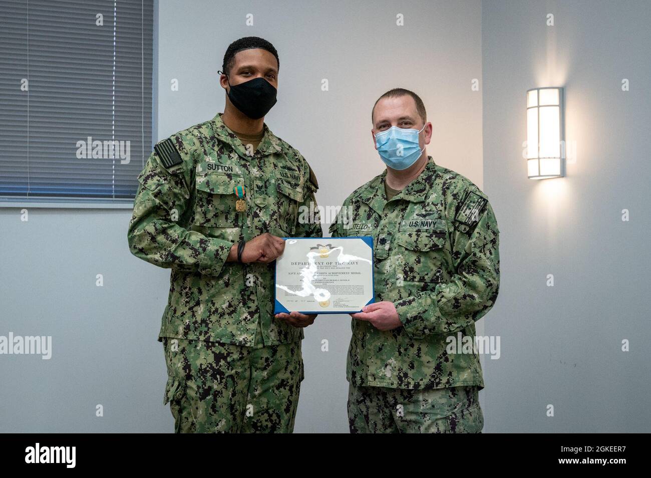 WASHINGTON, DC (March 30, 2021) – Cmdr. Anthony Militello (right), Naval Support Activity Washington executive officer, presents Boatswain’s Mate 1st Class Michael Sutton (left) with the Navy and Marine Corps achievement medal during an end-of-tour award ceremony held in Sutton’s honor. Stock Photo