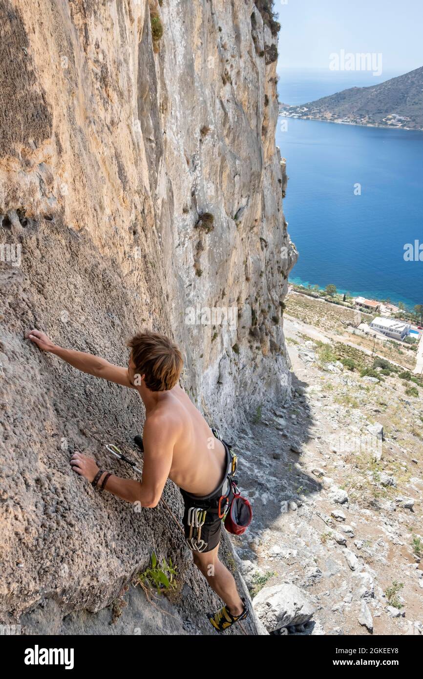 Young man climbing on a rock face, lead climber, sport climbing, Kalymnos, Dodecanese, Greece Stock Photo