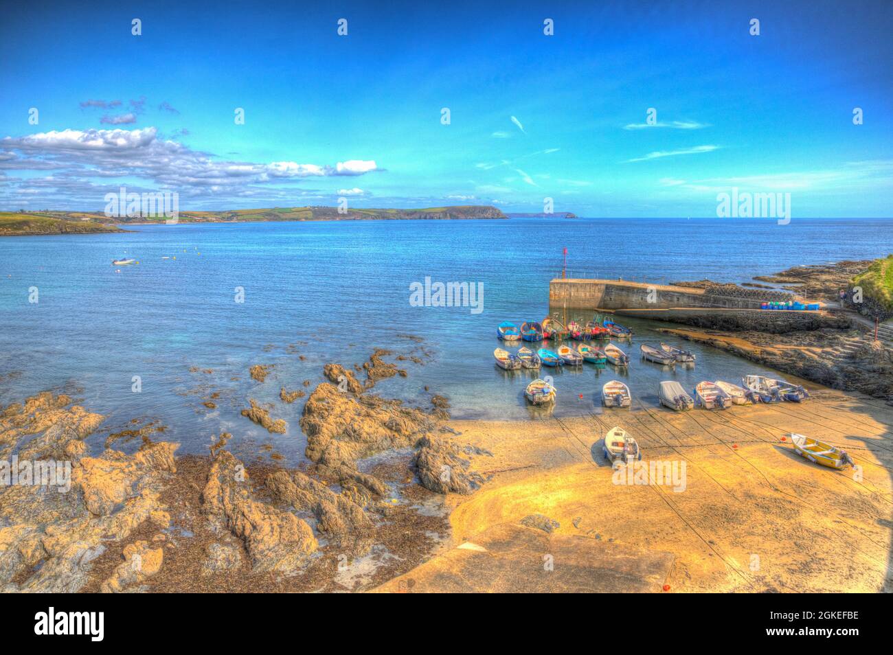 Portscatho Cornwall harbour wall with boats south west coast of England UK colourful hdr Stock Photo
