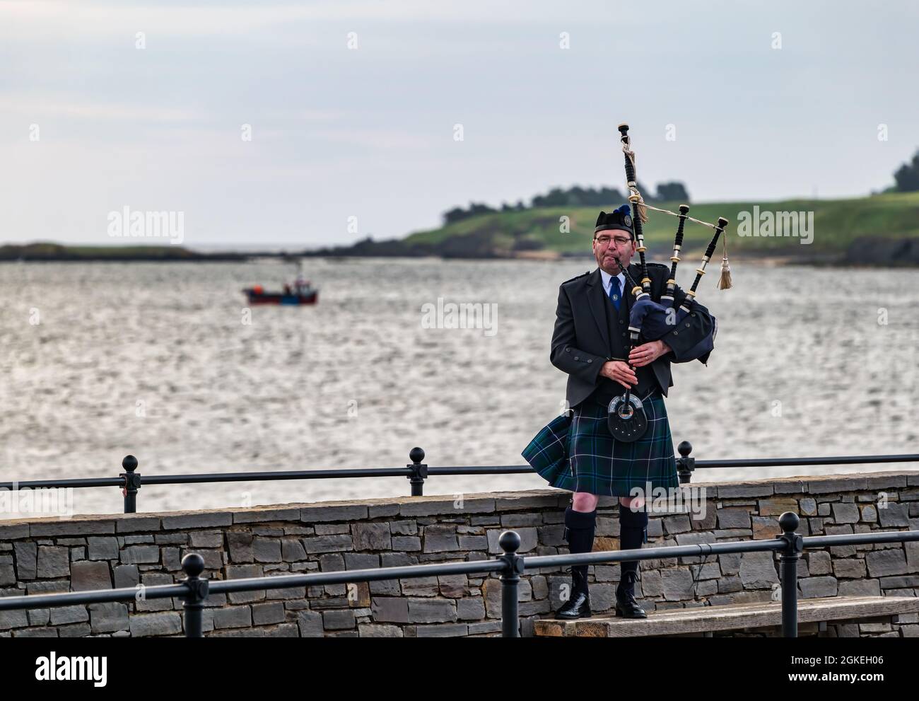 Piper plays bagpipes at dawn commemorating St Valery Day when Scottish
