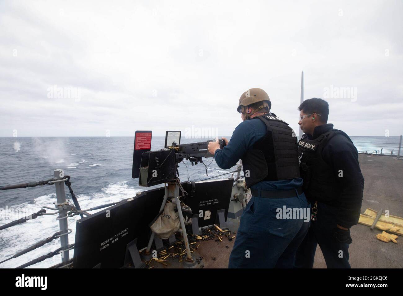 210331-N-CJ510-0816 MEDITERRANEAN SEA (March 31, 2021) Gunner’s Mate 2nd Class Jesse Chavez, right, observes as Gunner’s Mate 3rd Class Paul Wolfe fires a .50 caliber machine gun aboard the Arleigh Burke-class guided-missile destroyer USS Roosevelt (DDG 80) during a crew served weapons shoot, March 31, 2021. Roosevelt, forward-deployed to Rota, Spain, is on its second patrol in the U.S. Sixth Fleet area of operations in support of regional allies and partners and U.S. national security interests in Europe and Africa. Stock Photo