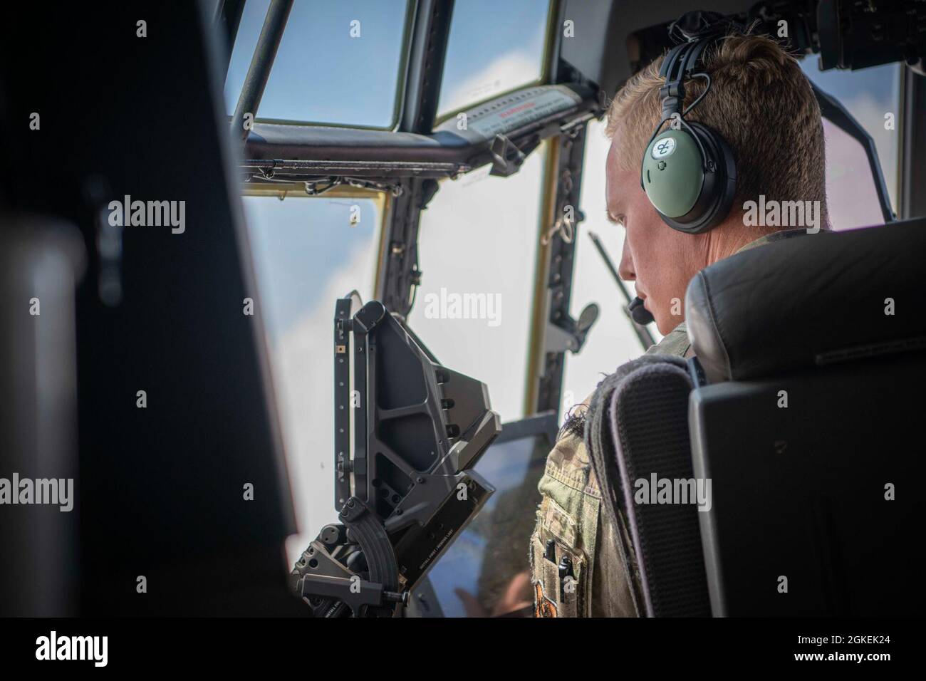 U.S. Air Force Capt. Jordan Webb, an AC-130J Ghostrider pilot assigned to the 4th Special Operations Squadron, looks out the window as a 105mm cannon is fired from an AC-130J Ghostrider, Eglin Range Complex, Florida, March 31, 2021. The 492nd Special Operations Training Group is the Air Force Special Operations Command's formal school for the AC-130J Ghostrider and MC-130H Talon II. They are responsible for assessing, educating and professionally developing SOF Airmen and rapidly developing innovative courses and technologies to meet emerging AFSOC requirements. Stock Photo