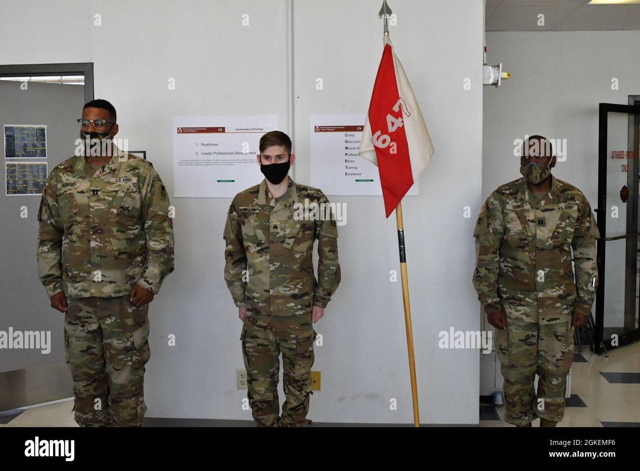 Newly promoted Sgt. Dalton Skiles, demobilization specialist, middle, and Capt. Richard Berrouet, operations assistant officer in charge, left, both assigned to 647th Regional Support Group (Forward), Fort Bliss Mobilization Brigade; and Capt. Benjamin Gaines, commander, Headquarters and Headquarters Company, 647th Regional Support Group (Forward), Fort Bliss Mobilization Brigade, stand at attention during a promotion ceremony at Fort Bliss, Texas, March 31, 2021. Stock Photo