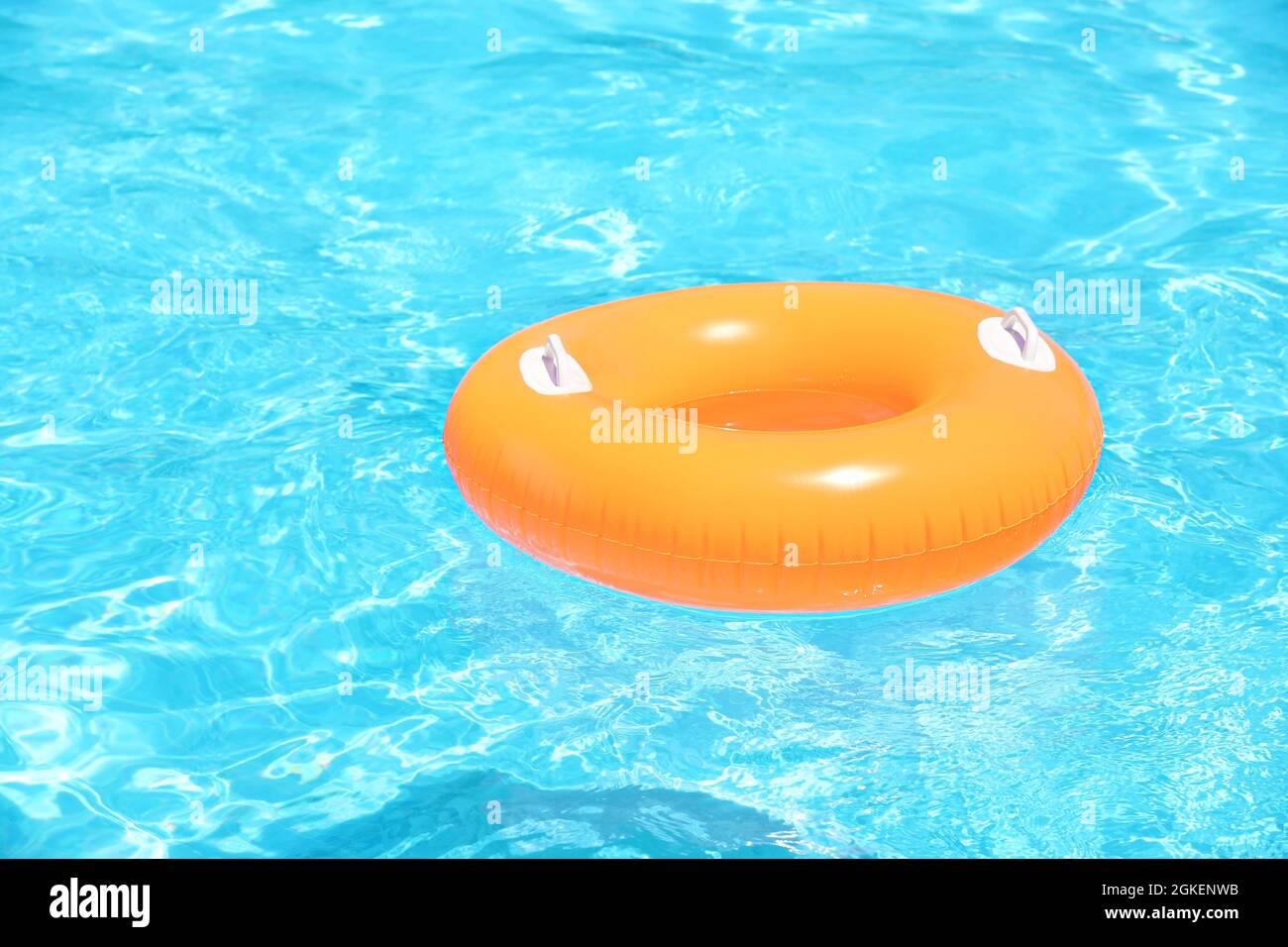Inflatable orange ring in blue swimming pool Stock Photo Alamy