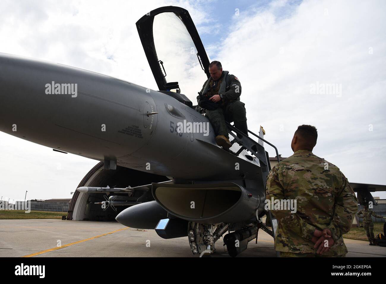 Lt. Gen. Scott Pleus, 7th Air Force commander, performs a preflight inspection on an F-16 Fighting Falcon with Senior Airman Mequail Fridge, 8th Aircraft Maintenance Squadron crew chief, on the flightline at Kunsan Air Base, Republic of Korea, April 1, 2021. During his visit, Pleus held a mentorship session with Kunsan’s company grade officers, toured the O’Malley Dining Facility, visited the fighter squadrons and more. Stock Photo