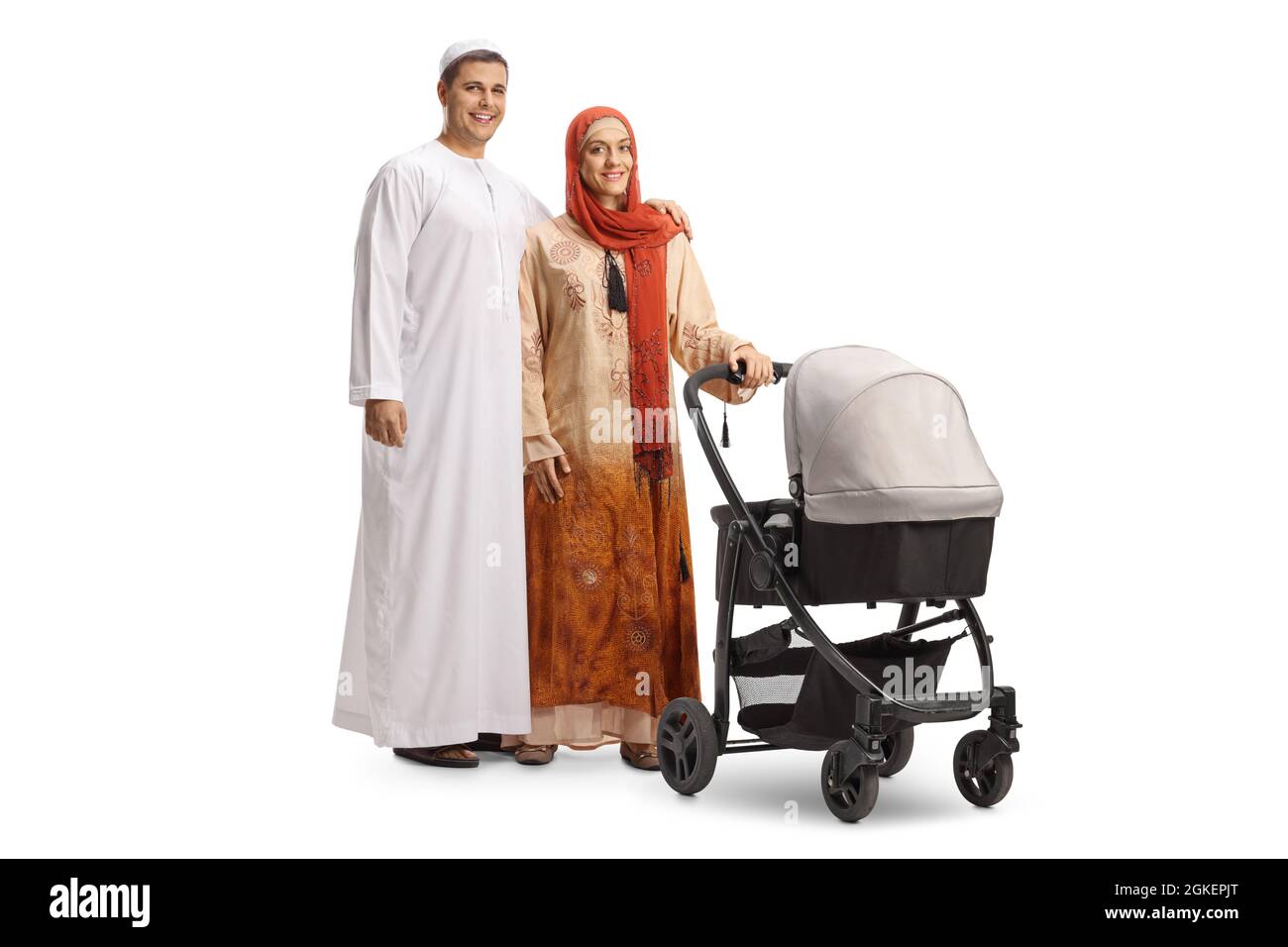 Young man and woman in ethnic clothes standing with a baby stroller isolated on white background Stock Photo