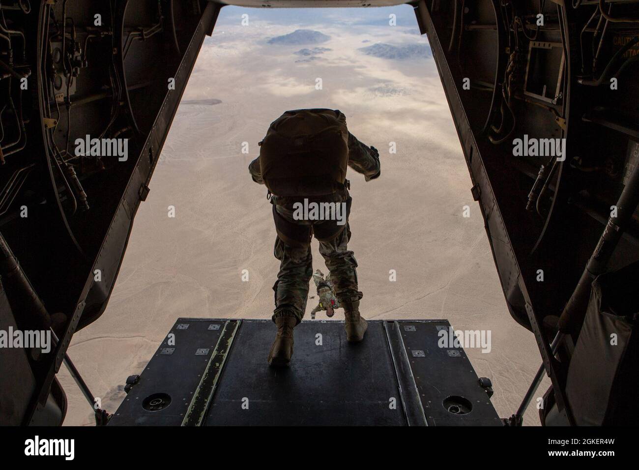 U.S. Army Soldiers assigned to 10th Special Forces Group (Airborne) jump out of an MV-22B Osprey helicopter with Marine Medium Tiltrotor Squadron (VMM) 365 at Marine Air-Ground Combat Center, California, April 1, 2021. Marines with Marine Medium Tiltrotor Squadron 365 and Soldiers with 10th SFG (A) prepare for future conflicts in the integrated and joint environment provided by Service Level Training Exercise (SLTE) 3-21. SLTE is a series of exercises designed to train Marines for operations around the globe by increasing their ability to operate and conduct offensive and defensive combat oper Stock Photo