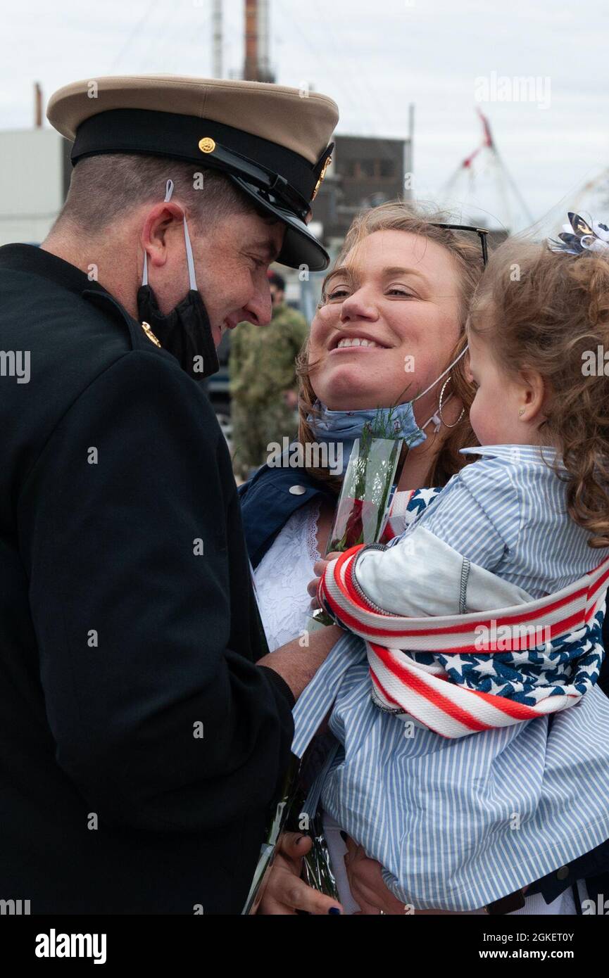 Senior Chief Machinist’s Mate (Auxiliary) James McDade is greeted by his wife Kristin and his 2-year-old daughter Sofia moments after USS Providence (SSN 719) returned home to Naval Submarine Base New London in Groton, CT on Thursday, April 1, 2021 following its 16th and final deployment.  While on deployment for seven months, Providence steamed over 50,000 miles, which is equivalent to twice around the world. Stock Photo