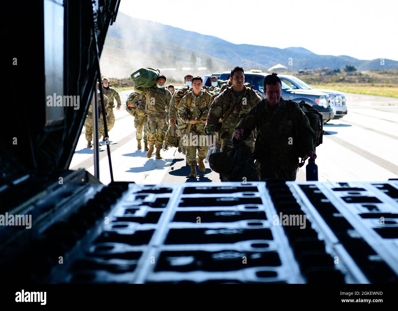 Soldiers from the 25th Infantry Division prepare to board a C130J