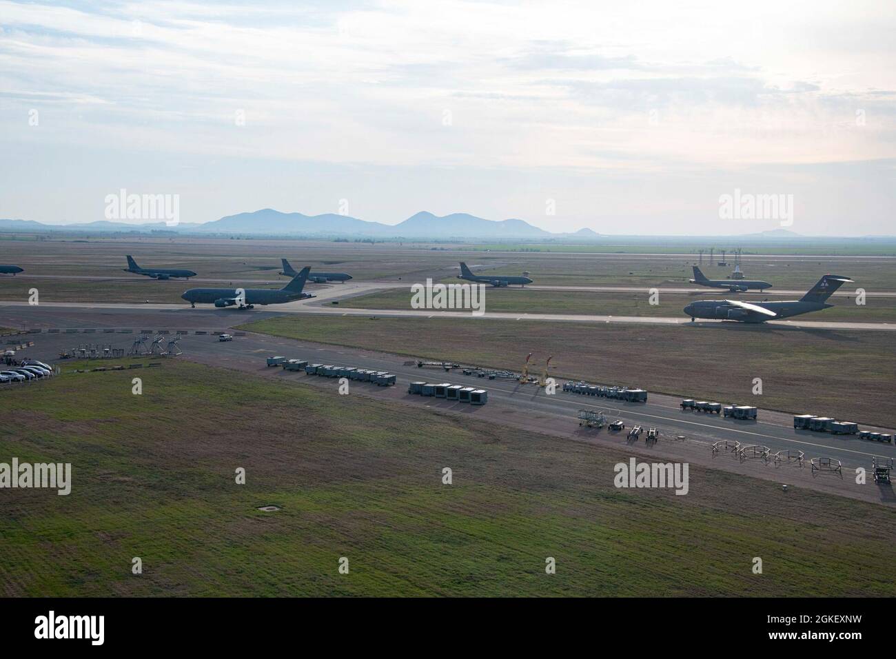 U.S. Air Force KC-135 Stratotankers, KC-46 Pegasus and C-17 Globemaster IIIs line up for a large formation exercise April 2, 2021, at Altus Air Force Base, Oklahoma. The exercise tests the base’s ability to relocate aircraft before impending storms that are common in Oklahoma. Stock Photo