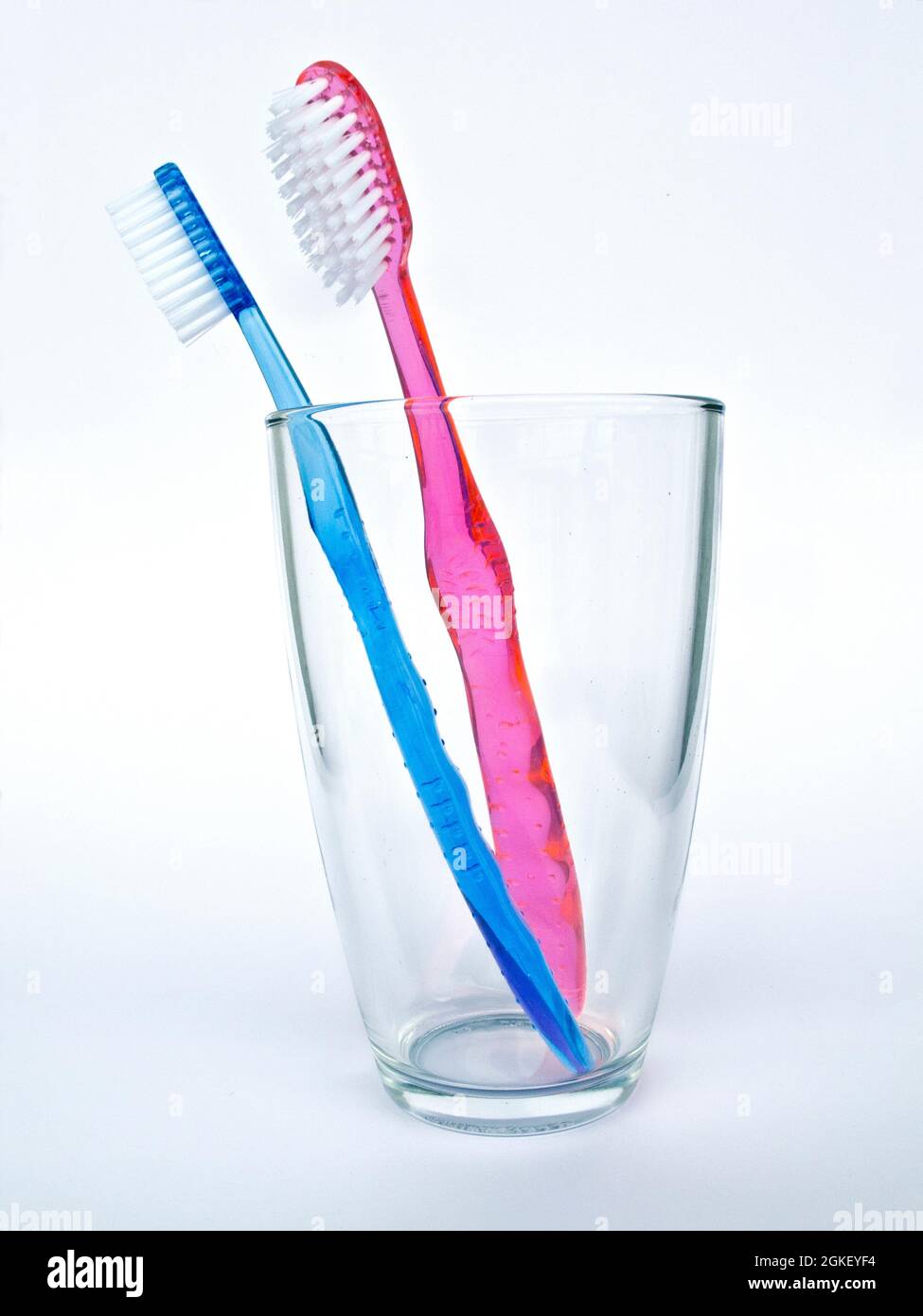 Tooth brushes in a glass isolated on white background Stock Photo - Alamy