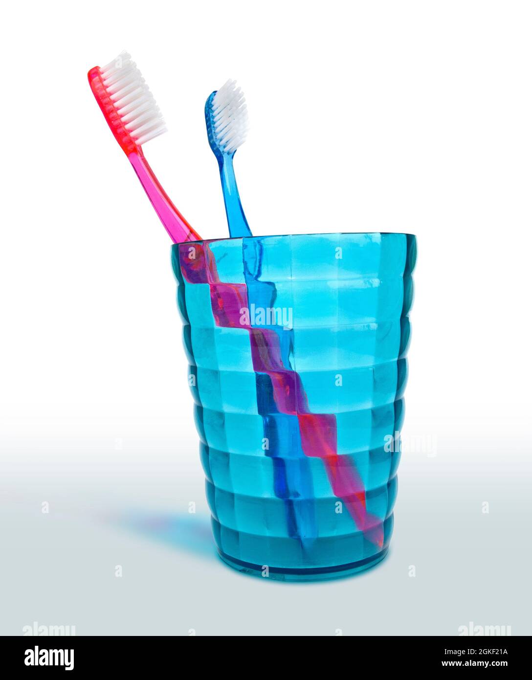 Tooth brushes in a glass isolated on white background Stock Photo - Alamy