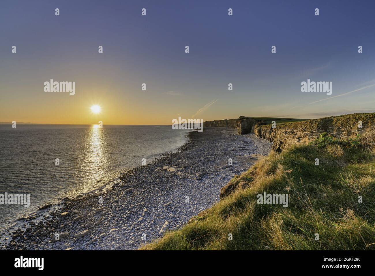 Landscape of a shore covered in greenery surrounded by the sea during ...