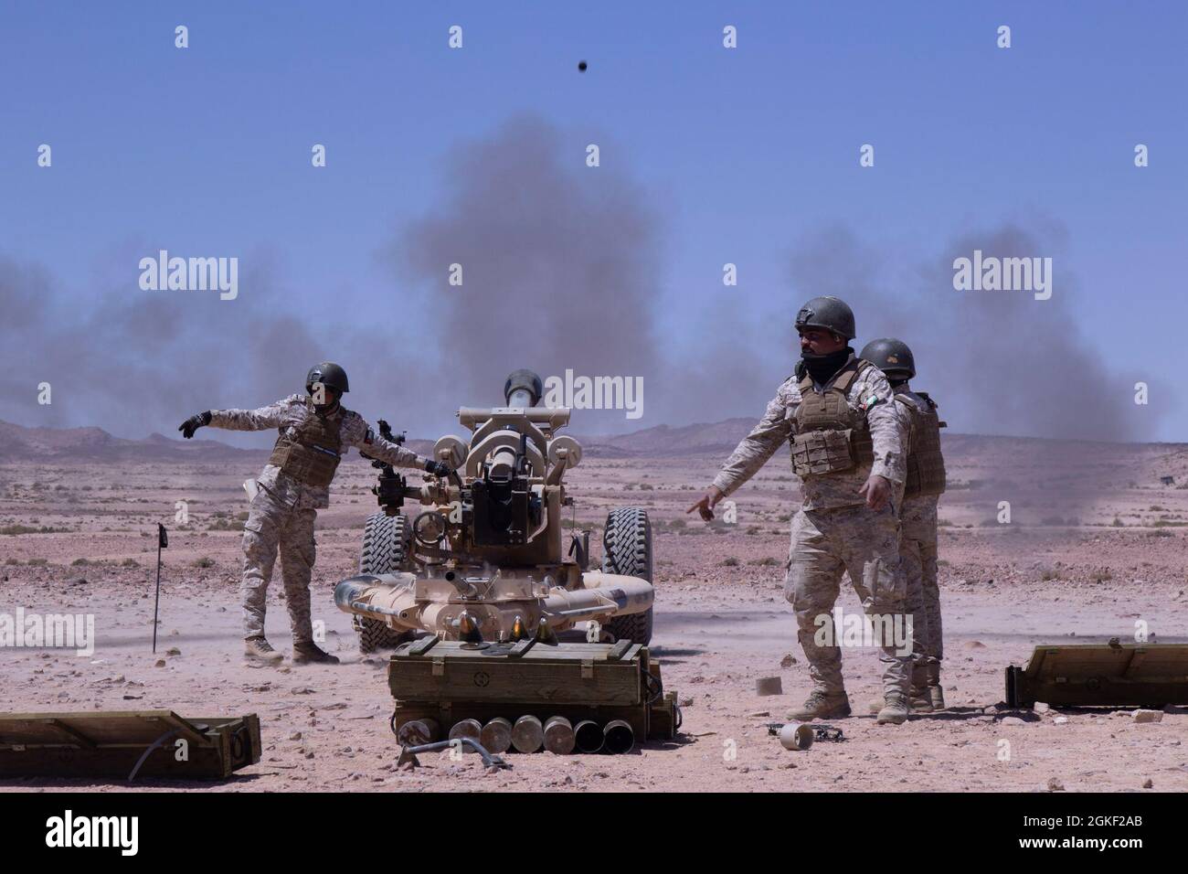 QRF Brigade field artillery gun crew fire the M119A2 105mm Howitzer at the Al Quwayrah Training Area, Jordan. The artillery gun crew, a mortar crew, and Jordanian Royal Marines participated in live fire exercise over the course of a week. Stock Photo