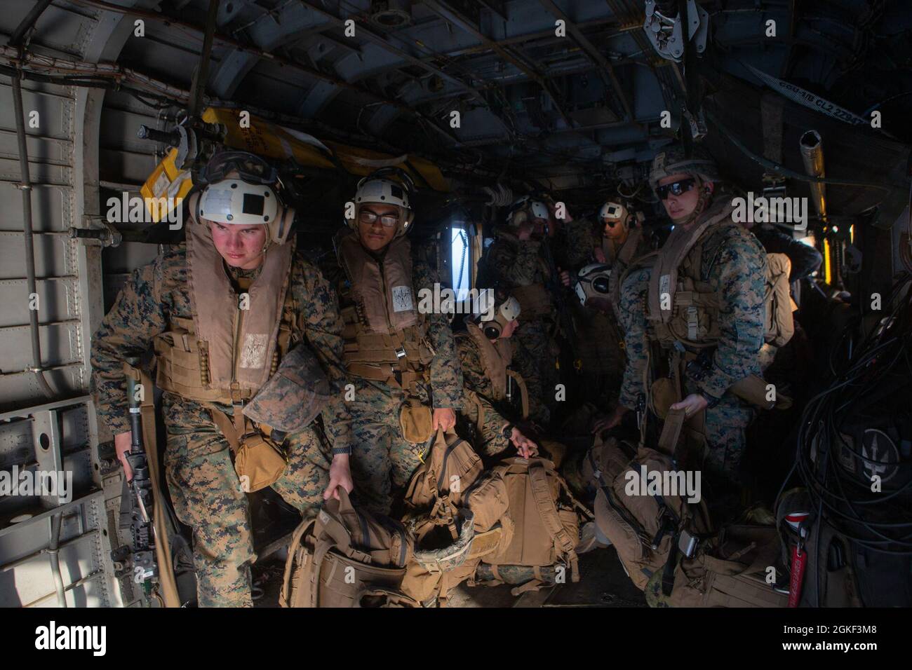 U.S. Marines with 2nd Combat Engineer Battalion prepare to exit a CH-53E Super Stallion assigned to Marine Heavy Helicopter Squadron (HMH) 461 after landing on the USNS D. T. Williams (T-AK-3009), April 5, 2021. 2nd Marine Aircraft Wing is participating in Dynamic Cape an operational logistics exercise simulating a Marine expeditionary force’s ability to exercise command and control in a contested environment as well as exercising naval integration in a joint environment. 2nd CEB is a subordinate unit of 2nd Marine Division, the ground combat element of II Marine Expeditionary Force. HMH-461 i Stock Photo