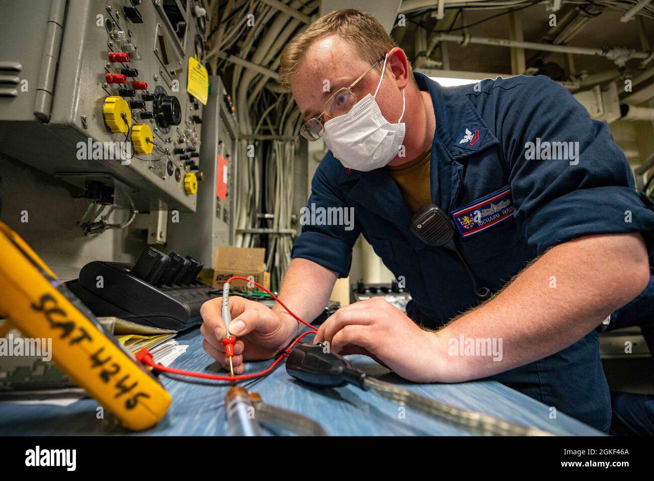 SOUTH CHINA SEA (April 05, 2021) – Electronics Technician 2nd Class, Richard Wade, conducts preventative maintenance on Arleigh-Burke-class guided-missile destroyer USS Barry (DDG 52) during routine underway operations. Barry is assigned to Task Force 71/Destroyer Squadron FIFTEEN (DESRON 15), the Navy’s largest forward deployed DESRON and the U.S. 7th Fleet’s principal surface force. Stock Photo