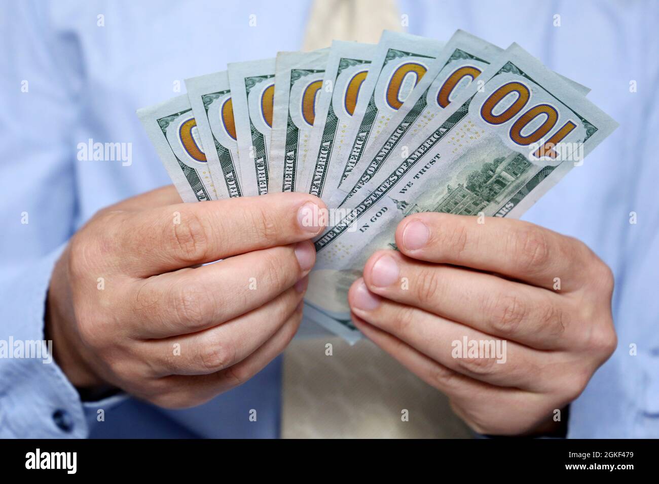 US dollars in male hands close up, man in business clothes counting the money. Concept of wages, bribe, financial assistance or loan Stock Photo