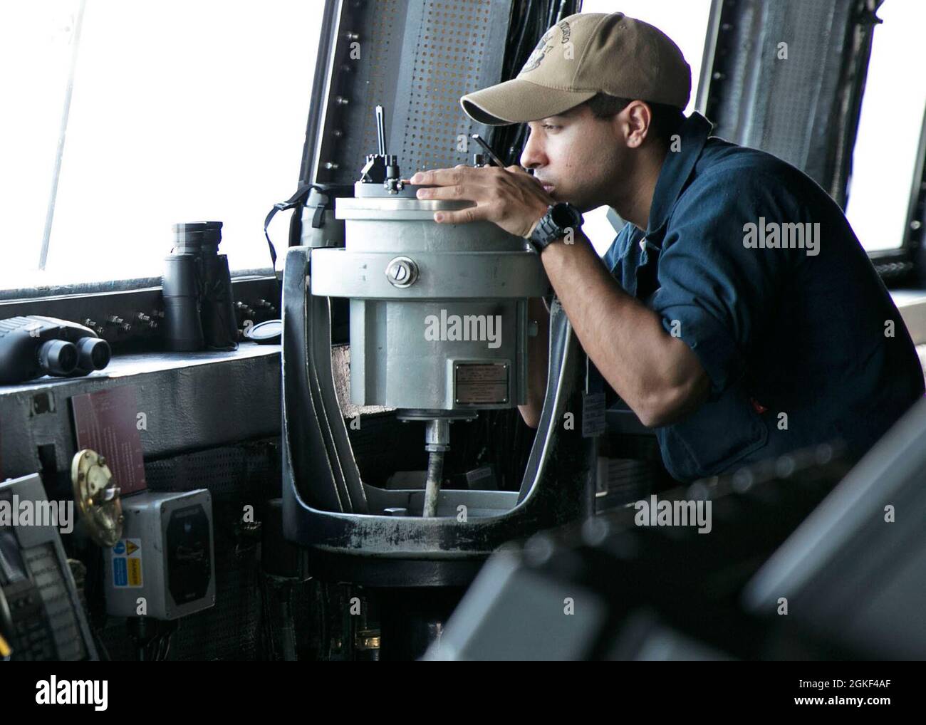 210405-N-OI940-1010  ATLANTIC OCEAN (April 5, 2021)  Ensign Jason Taylor, assigned to the amphibious transport dock ship USS San Antonio (LPD 17), gathers the bearings of a surface contact using a telescopic alidade on the ship's bridge, April 5, 2021. San Antonio is operating in the Atlantic Ocean with Amphibious Squadron 4 and the 24th Marine Expeditionary Unit (24th MEU) as part of the Iwo Jima Amphibious Ready Group. Stock Photo