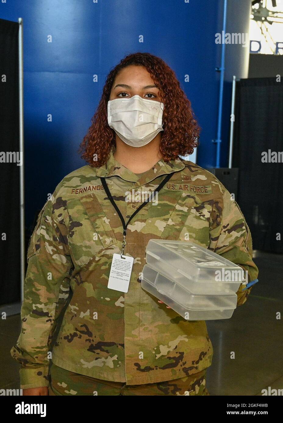 U.S. Air Force Senior Airman Amiee Fernandez, a Miami native and medical logistician with the 88th Medical Support Squadron, 88th Air Base Wing stationed at Wright-Patterson Air Force Base, Ohio, poses while waiting to deliver vaccines at the state-led, federally-supported Ford Field Community Vaccination Center in Detroit, April 6, 2021. Fernandez is part of a group of Airmen assigned to 1st Detachment, 64th Air Expeditionary Group who are assisting with the vaccination efforts. Her main responsibility is supporting the local community members by observing any reactions they may have after re Stock Photo