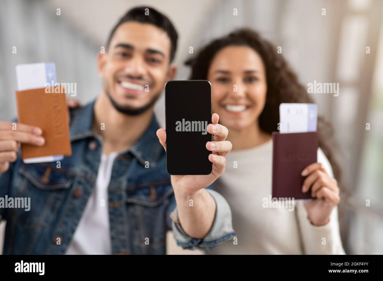 Happy Arab Couple With Passport And Tickets Demonstrating Smartphone ...