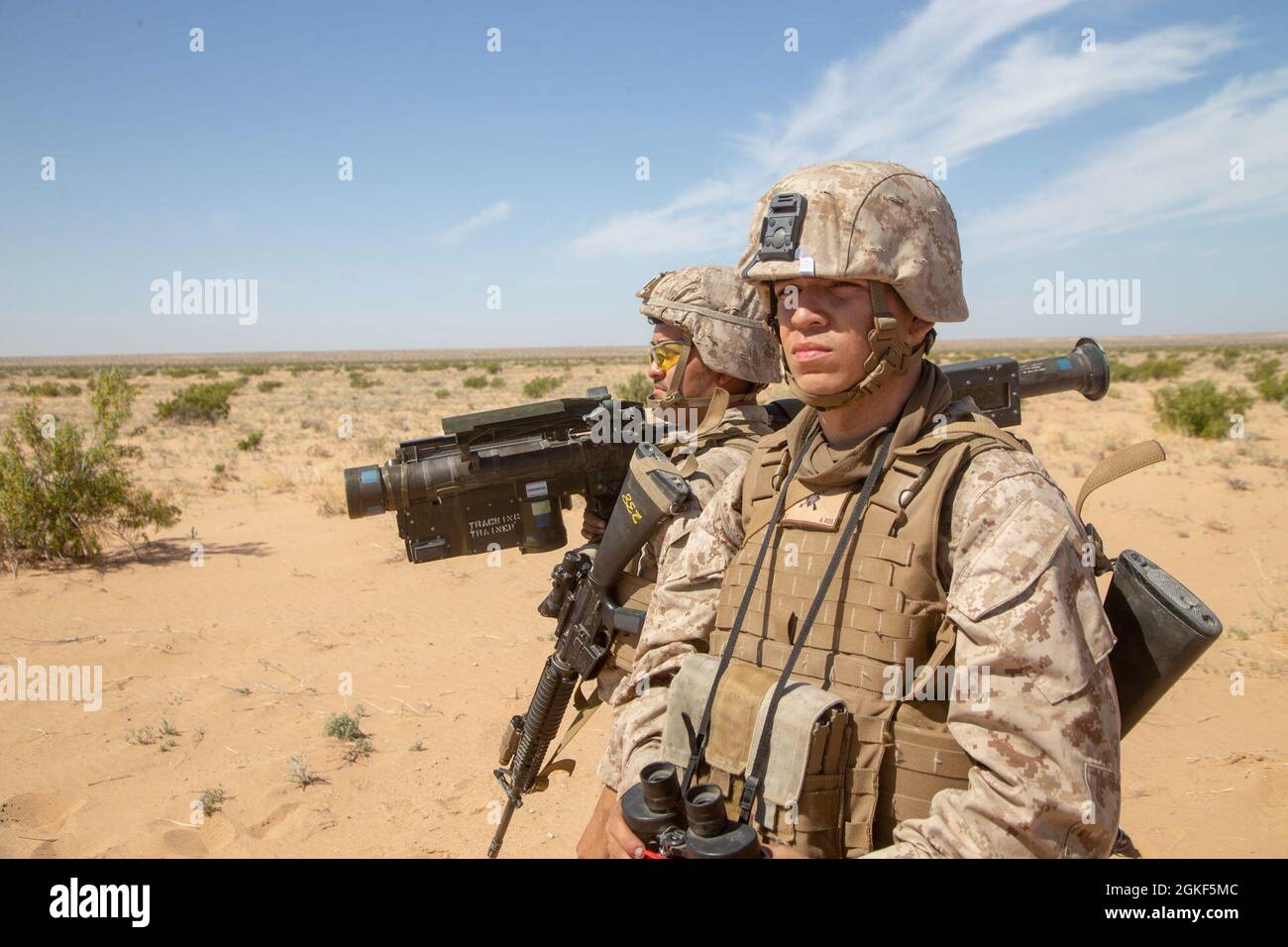 U.S. Marine Corps Pfc. Albert Salas, right, and Pfc. Saul Reta Jr., left, low altitude air defense gunners, both with 3rd Low Altitude Air Defense Battalion, Marine Air Control Group 38, 3rd Marine Aircraft Wing, demonstrate the use of a FIM-92 Stinger, during a ground base air defense exercise, at Auxiliary Airfield II, near Yuma, Ariz., April 6 2021.  The WTI course is a seven-week training event hosted by Marine Aviation Weapons and Tactics Squadron One, providing standardized advanced tactical training and certification of unit instructor qualifications to support Marine aviation training Stock Photo