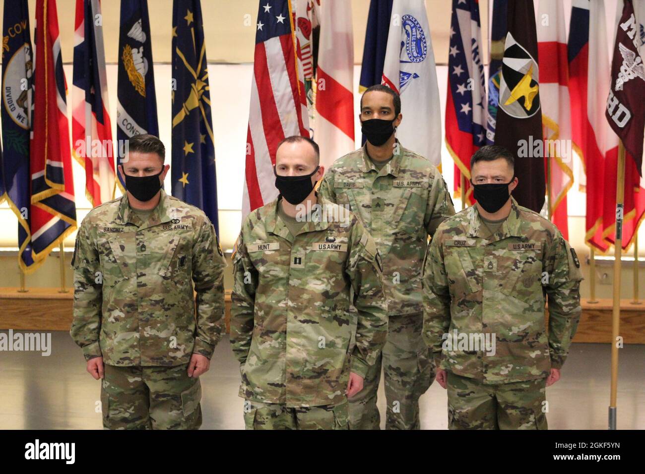 Sfc. Evan Sanchez (far left) joins Sfc. Daniel Cruz (far right) during ...