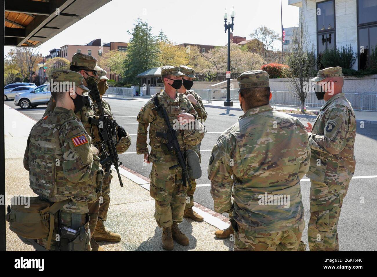 U.S. Army Master Sgt. Joshua Barker, far right, acting first sergeant of the task force and senior engineer of 101st Main Command Post Operational Detachment, Kentucky National Guard, addresses a group of Soldiers near the U.S. Capitol in Washington, D.C., April 6, 2021. The National Guard has been requested to continue supporting federal law enforcement agencies with security, communications, medical evacuation, logistics, and safety support to state, district and federal agencies through mid-May. Stock Photo