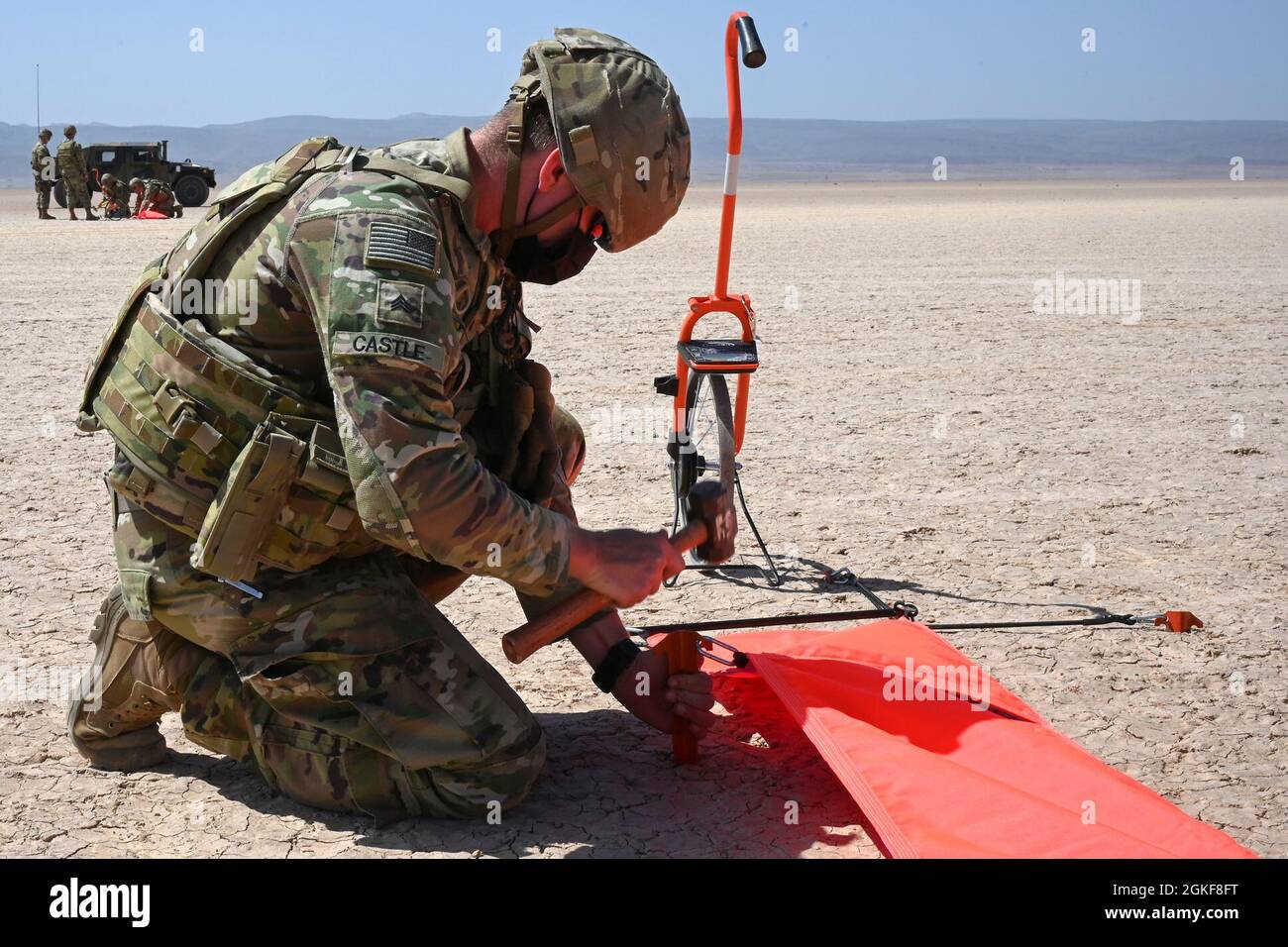 U.S. Army Sgt. Ethan Castle, an air traffic control (ATC) operator with the 2nd Battalion, 111th Aviation Regiment in support of Combined Joint Task Force-Horn of Africa (CJTF-HOA), sets up a VS-17 panel marker at Grand Bara, Djibouti, April 7, 2021. The team set up various VS-17 panel markers in order to mark a landing zone for a C-130 Hercules aircraft during a low-level landing exercise. Stock Photo