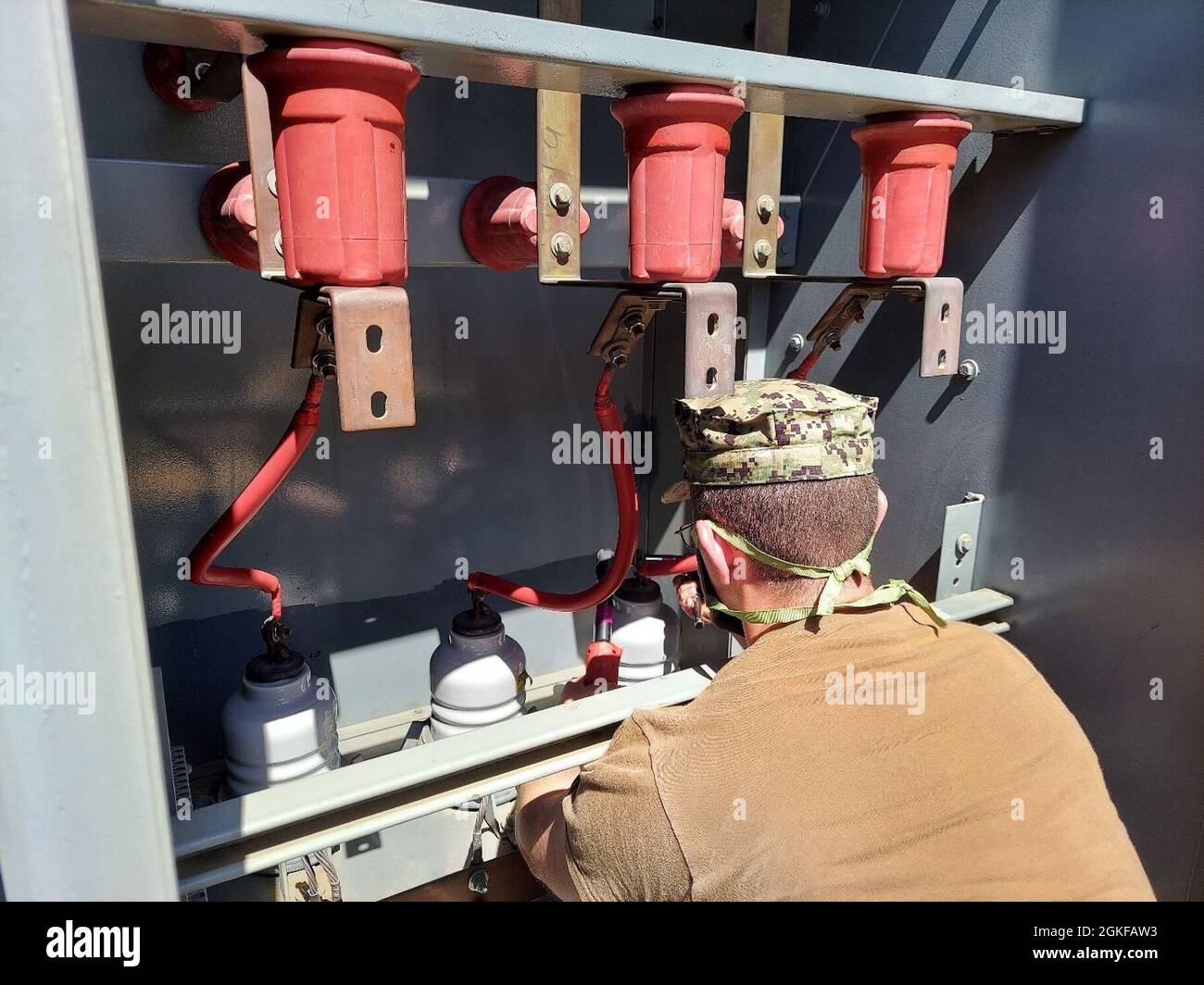 CM1 Jeremy Tatlock of NAVFAC EXWC MUSE reconnects lightning arrestors