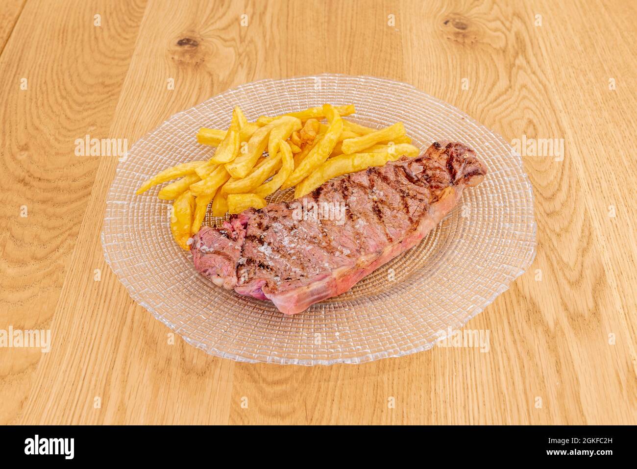 Grilled Galician beef entrecote with fried potatoes on a transparent