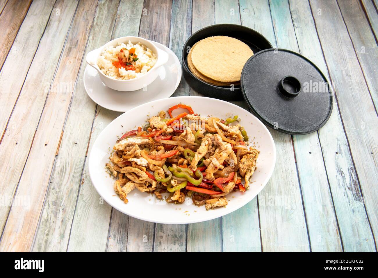 set of ingredients to prepare chicken fajitas with sautéed peppers