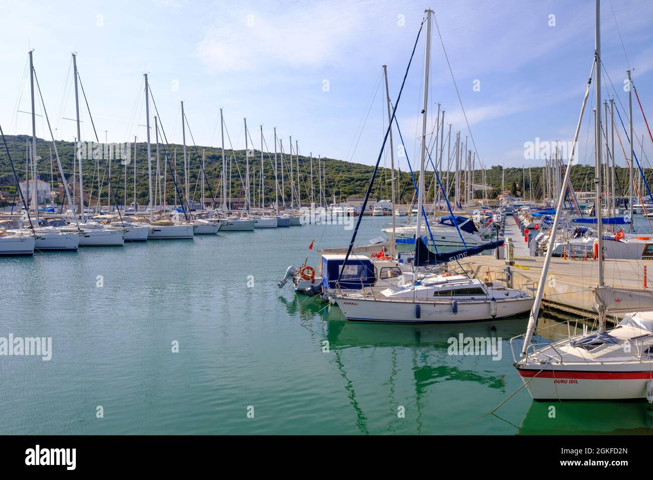 Seferihisar, Izmir, Turkey - 03.08.2021: seascape and landscape of Teos Marina and a lot of sailboats parked in a shiny day in Spring Stock Photo