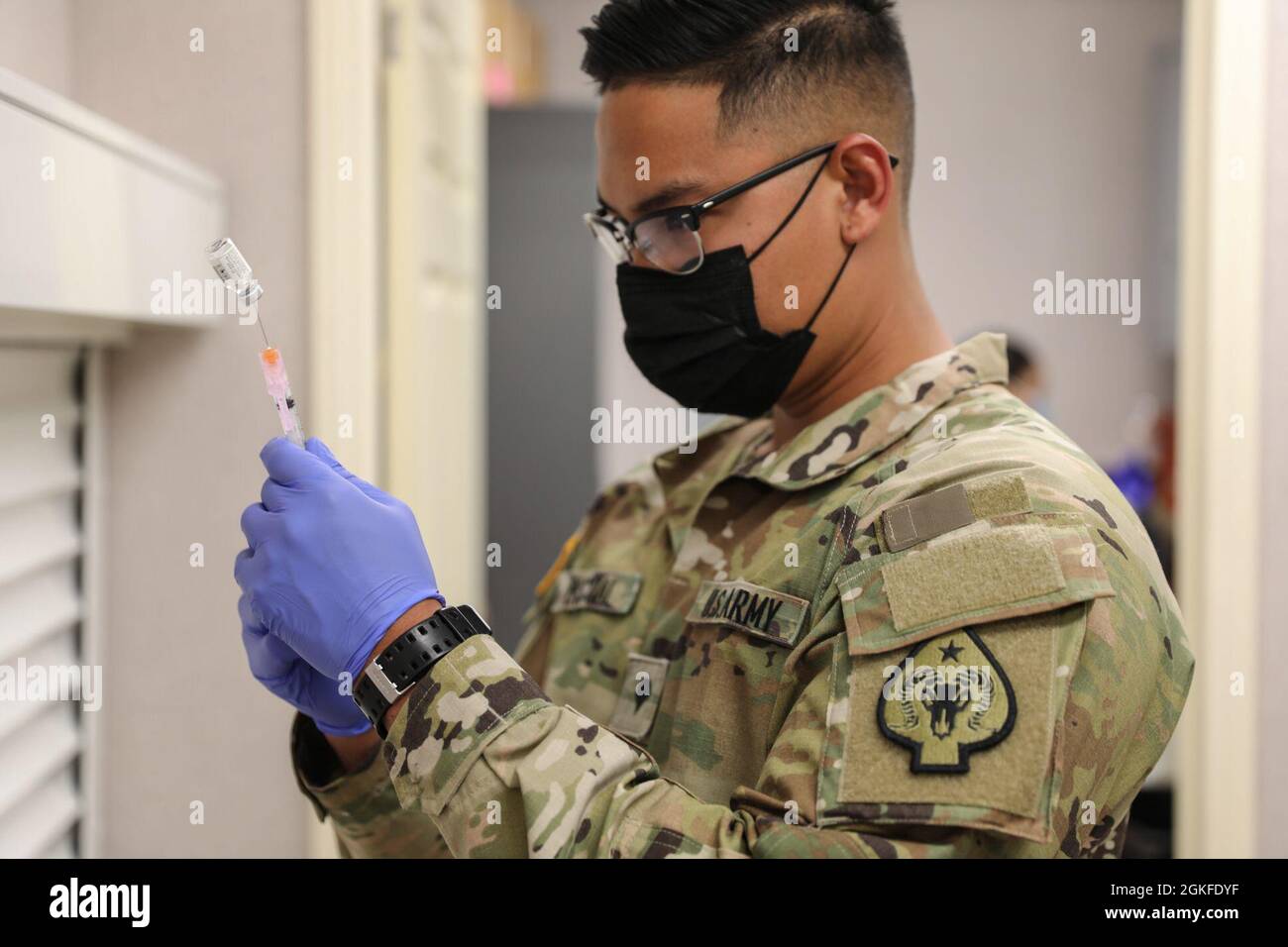 Spc. Exequiel Pascual with Joint Task Force 17 measures a dose of the Janssen vaccine at the mobile vaccination unit site, Thursday, April 8, 2021 in Pahrump, Nevada. Stock Photo